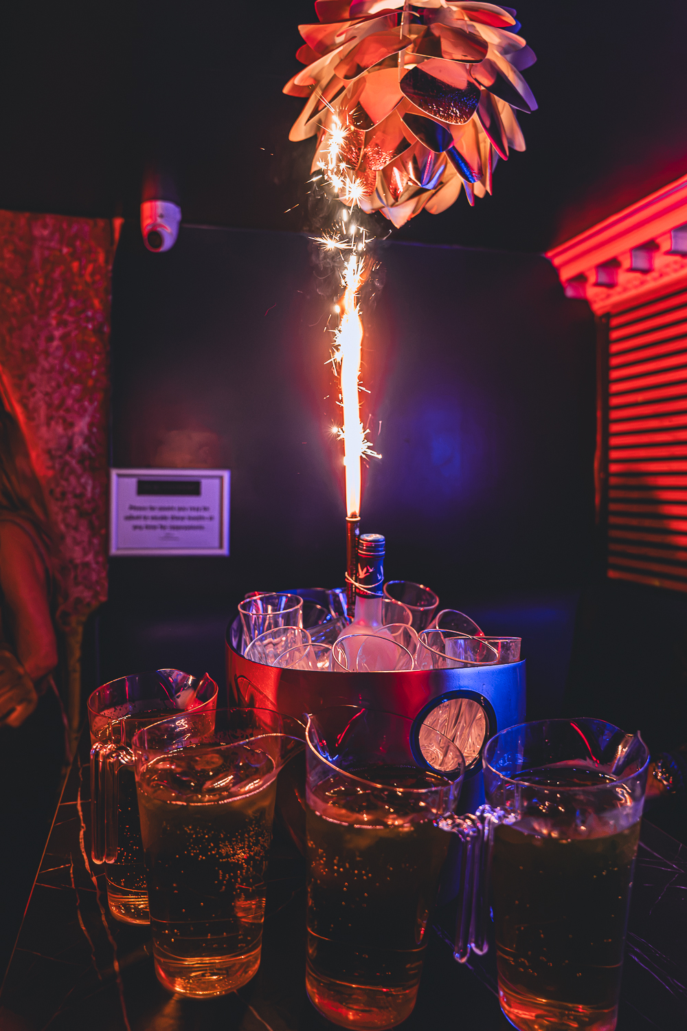 Jugs and an ice bucket served at a VIP booth table