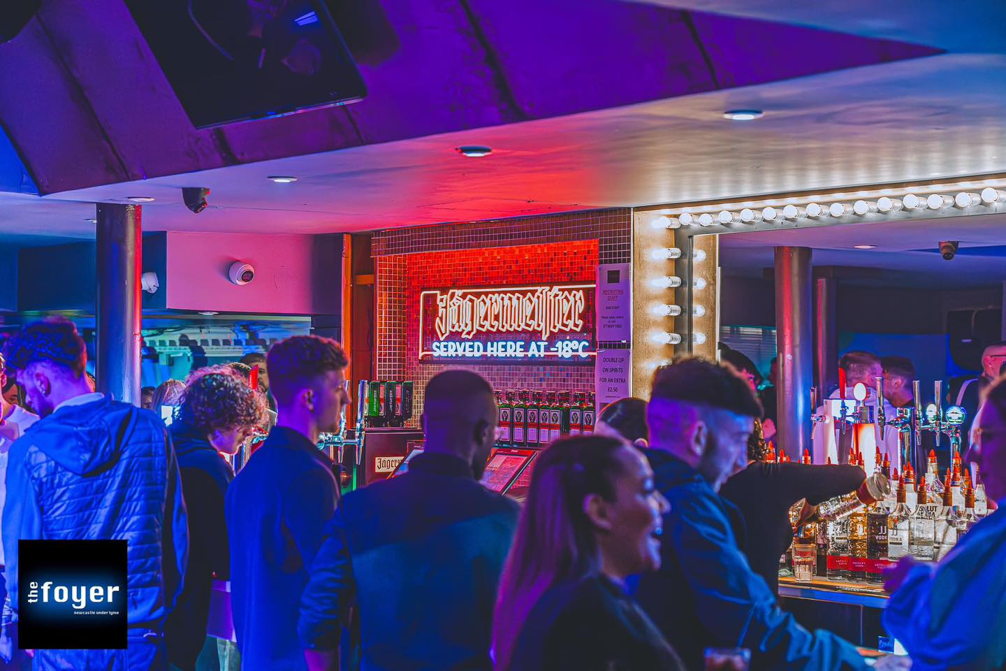 Friends at the neon-lit bar